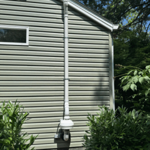 Variable Speed Radon fan installed on home with siding in Kentucky
