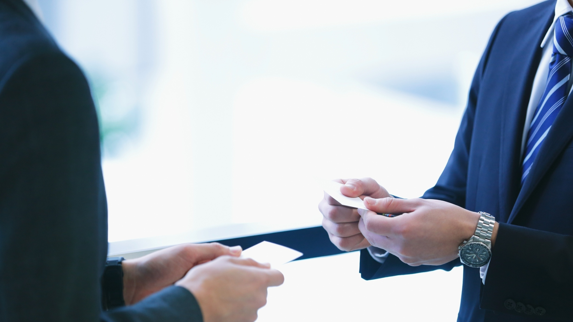 Builders exchanging cards