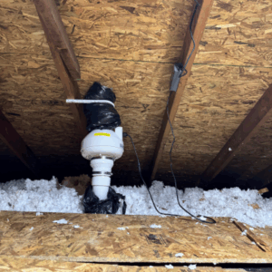 Pipe and fan in attic of a home to vent it safely outside.